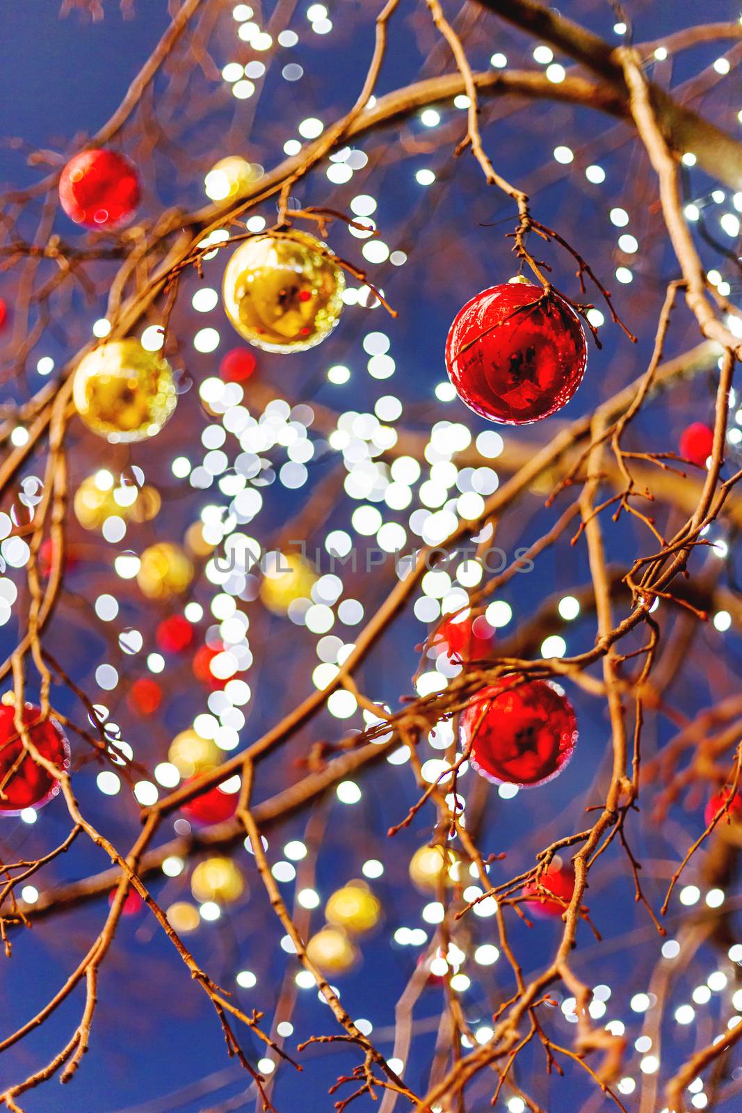 Streets of Moscow decorated for New Year and Christmas celebration. Tree with bright red and yellow balls. Russia.