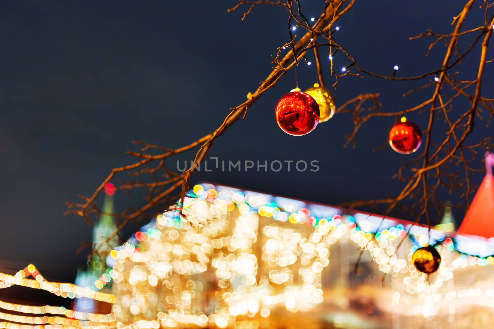 Streets of Moscow decorated for New Year and Christmas celebration. Tree with bright red and yellow balls. Russia.