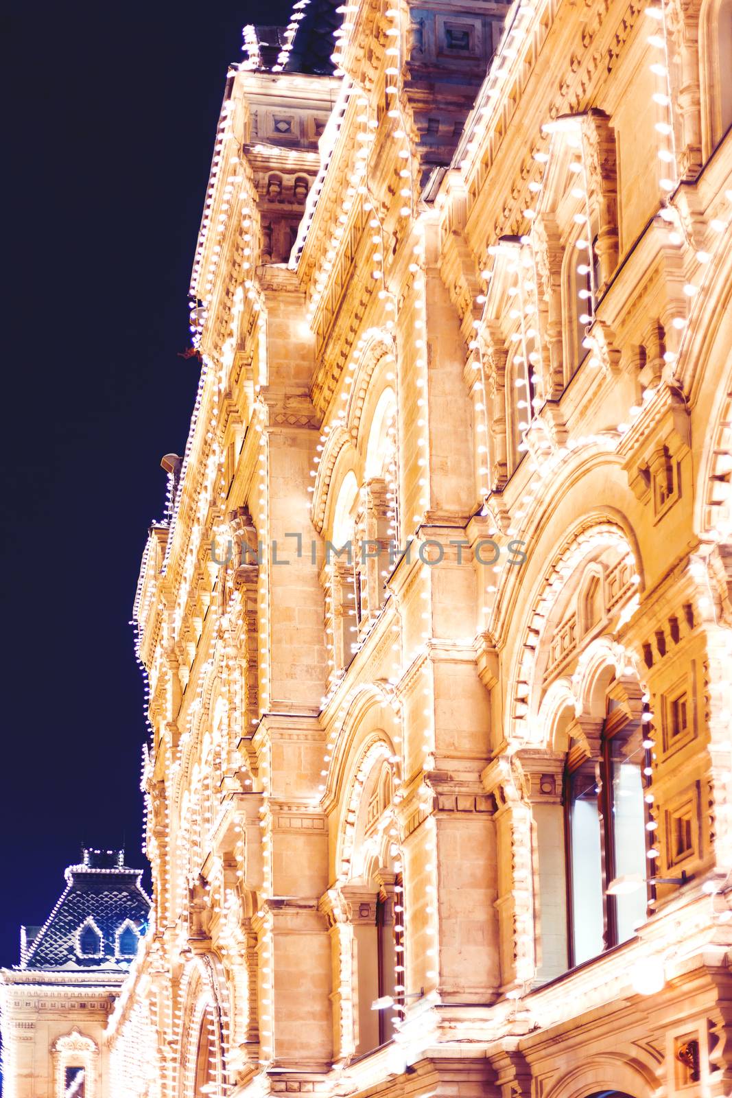 Streets of Moscow decorated for New Year and Christmas celebration. Main Department Store walls decorated with light bulbs. Russia. by aksenovko