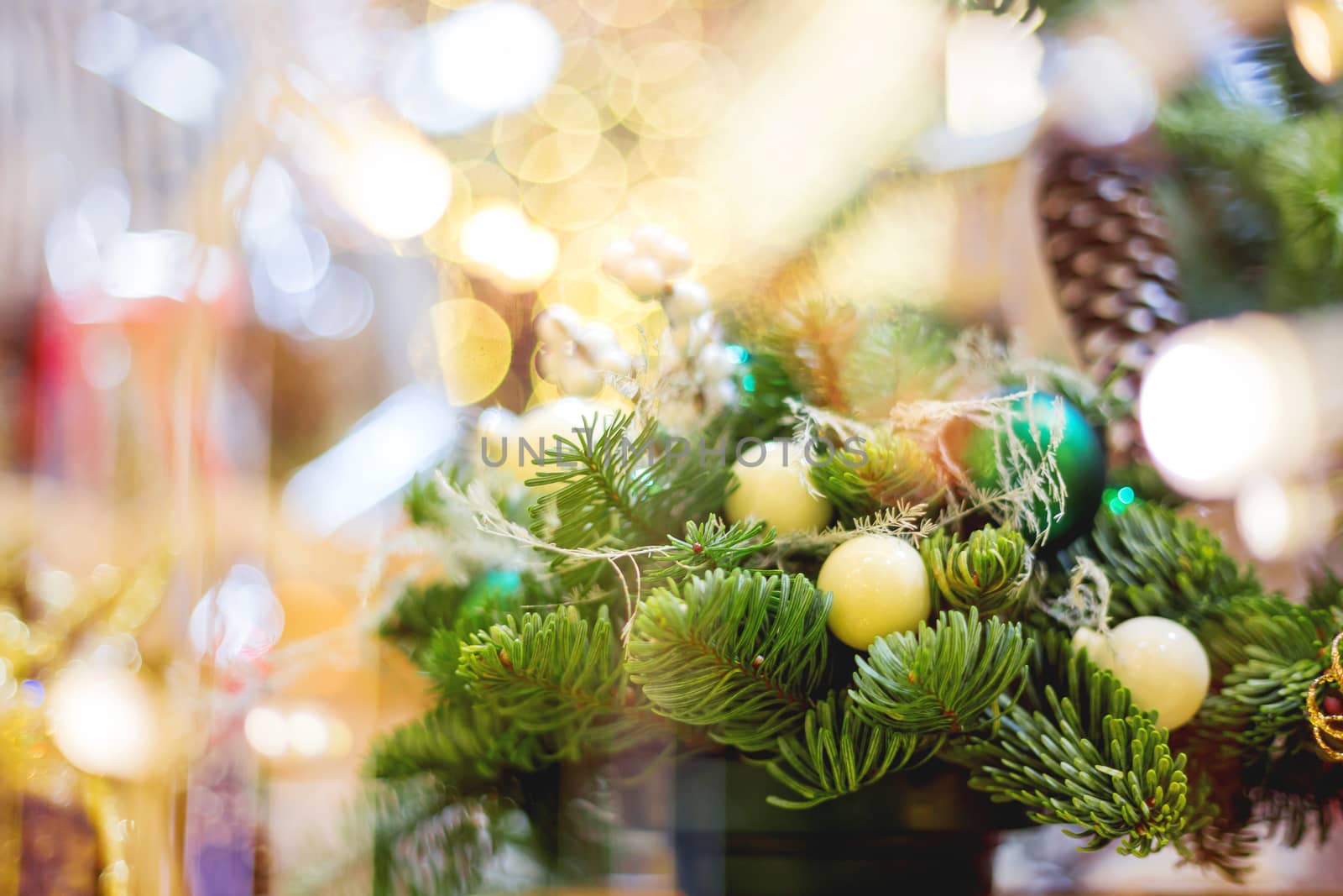 Christmas wreath made with pine and fir branches, white balls. Hand made New Year decoration with light bulbs.