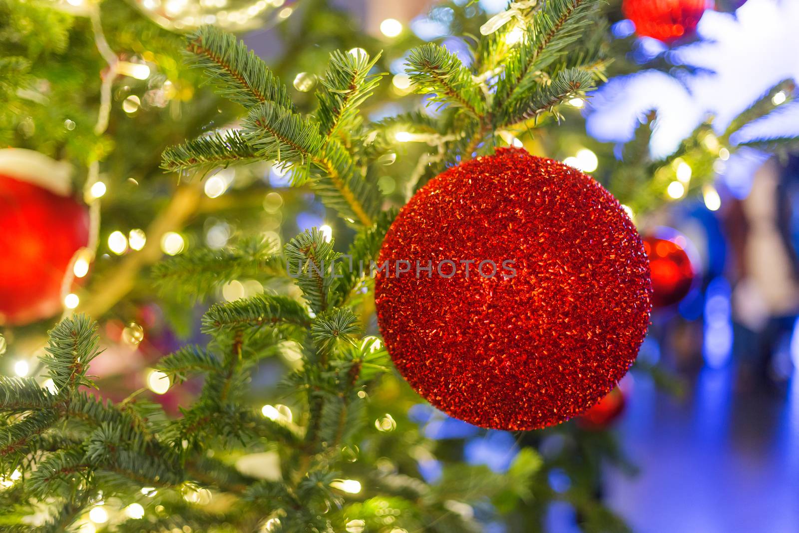 Streets decorated for New Year and Christmas celebration. Tree with bright red and yellow balls. Moscow, Russia.