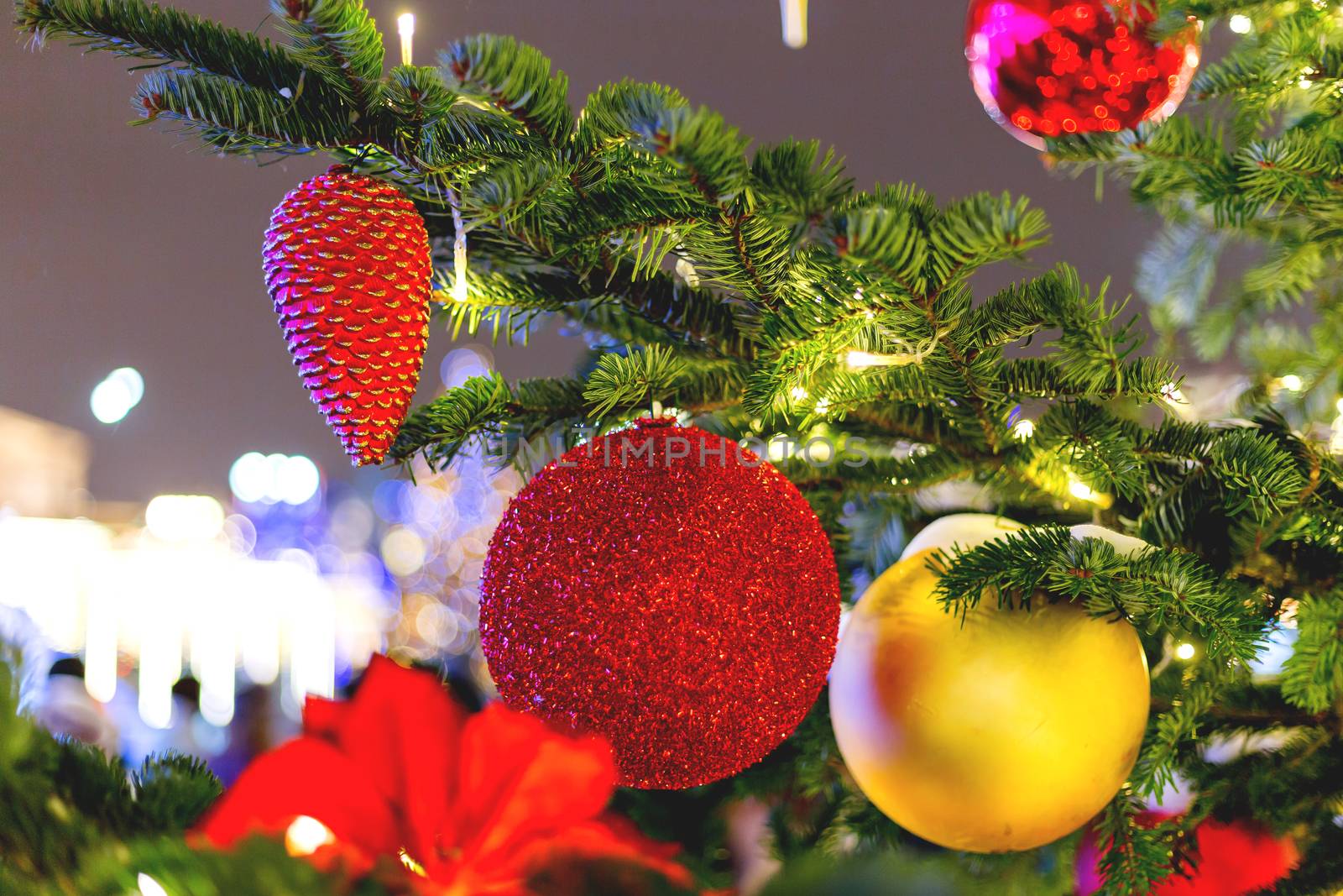 Streets decorated for New Year and Christmas celebration. Tree with bright red and yellow balls. Moscow, Russia.
