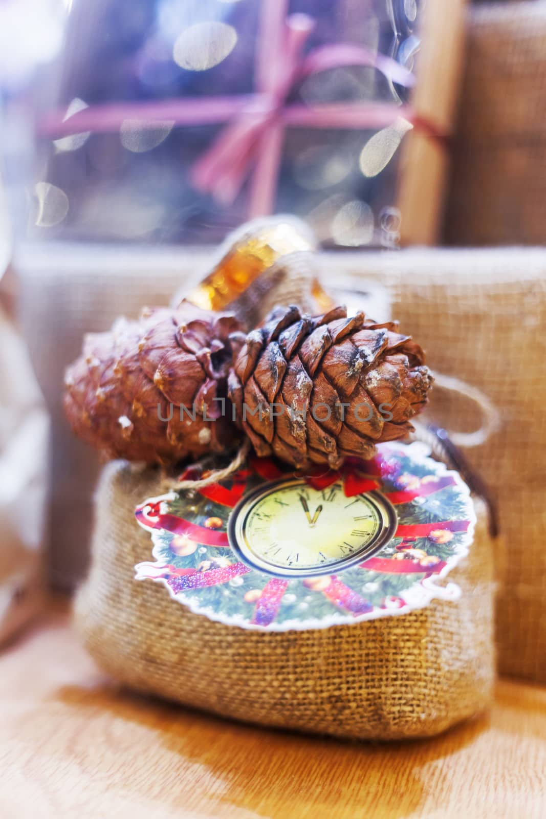 Christmas and New Year decoration - little bag made of burlap with pine cones and drawn clocks and wreath. Hand made present. Winter holiday gift.