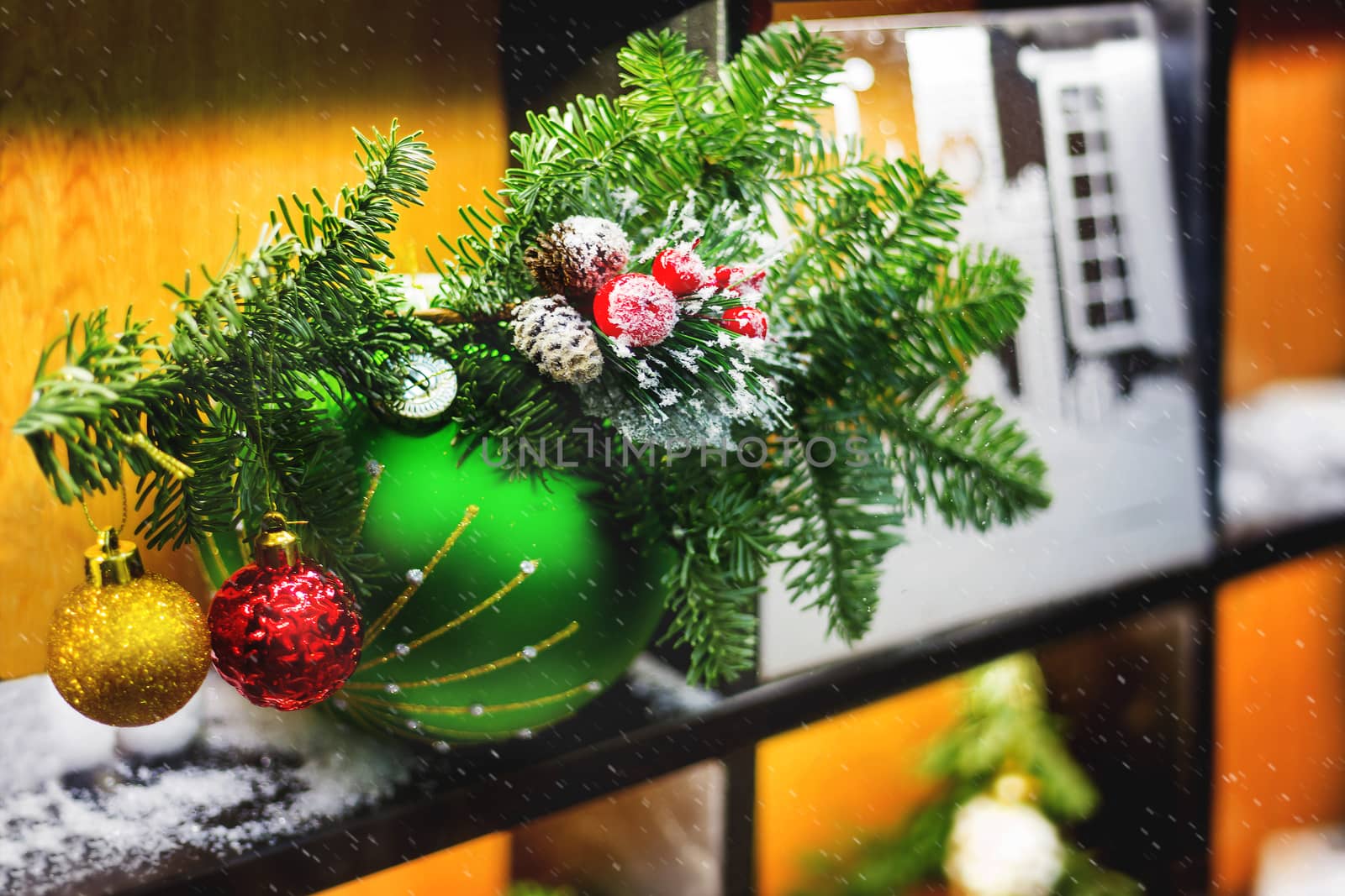 Christmas and New Year background with fir tree branch, bright decorative balls and snow. Decorations for celebration.
