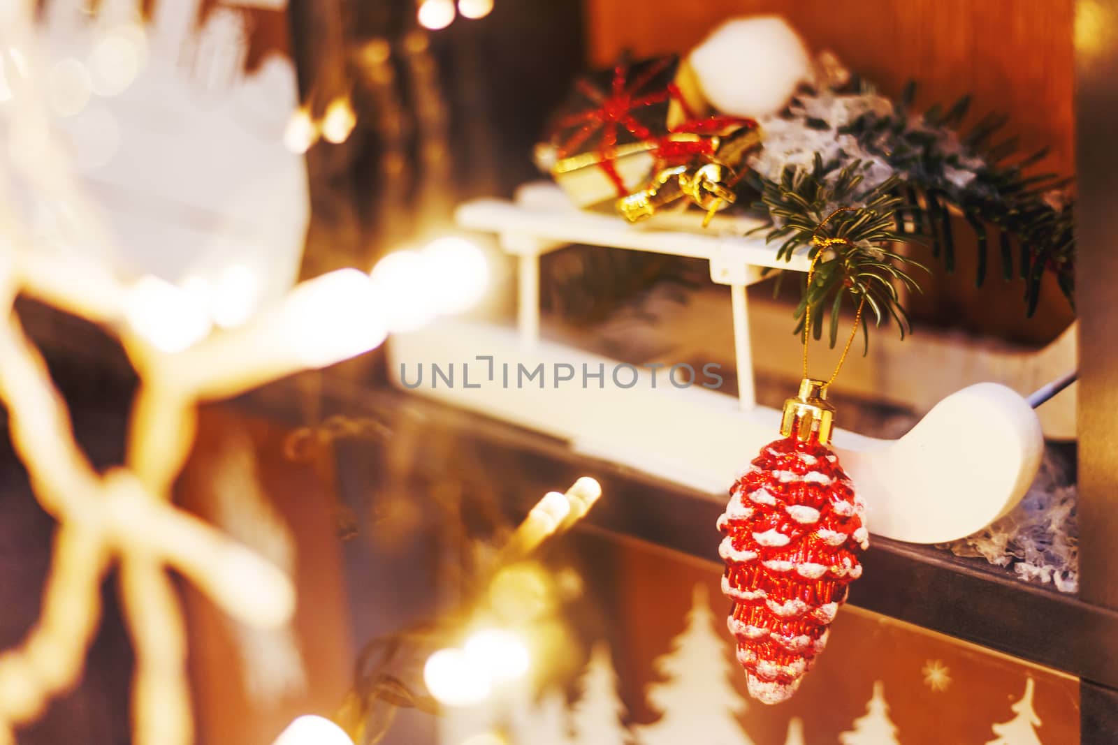 Christmas and New Year decorations - white wooden sledge with bright sparkling pine cone and fir tree branches.