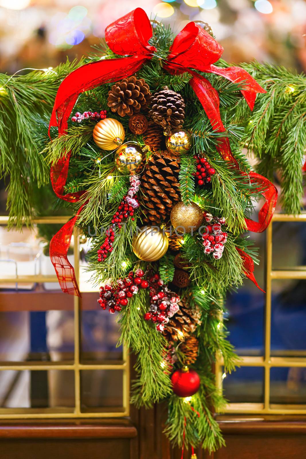 Fir tree wreath decorated with berries, pine cones and shiny balls for Christmas and New Year celebration. by aksenovko