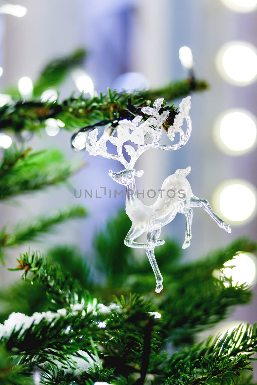 Outdoor decoration for New Year and Christmas celebration - transparetn figure of deer. Streets of Moscow decorated with light bulbs and colorful shiny balls. Russia.