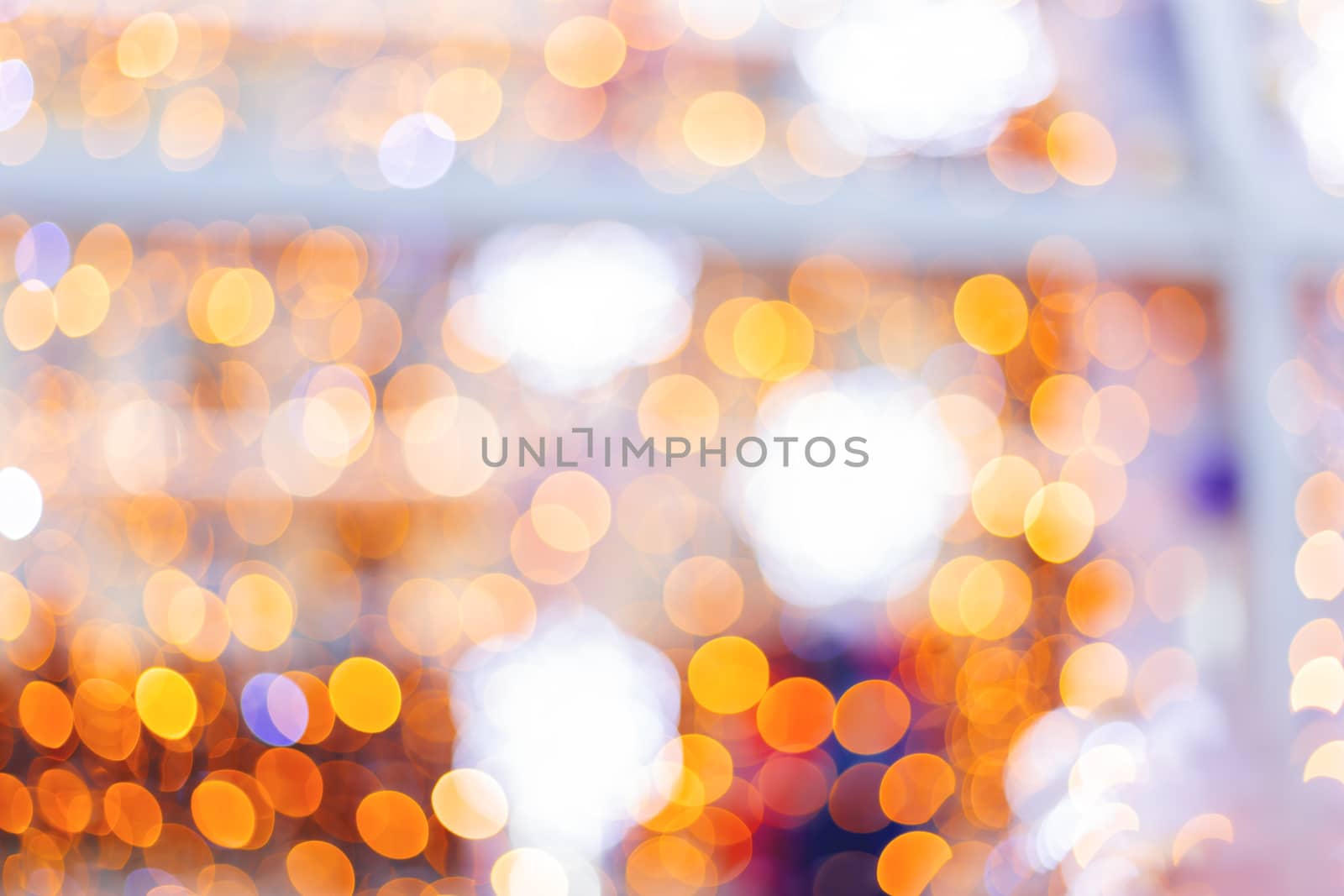 Defocused night street lights, blurred colorful bokeh background. Holiday colorful lanterns and light bulbs garlands.