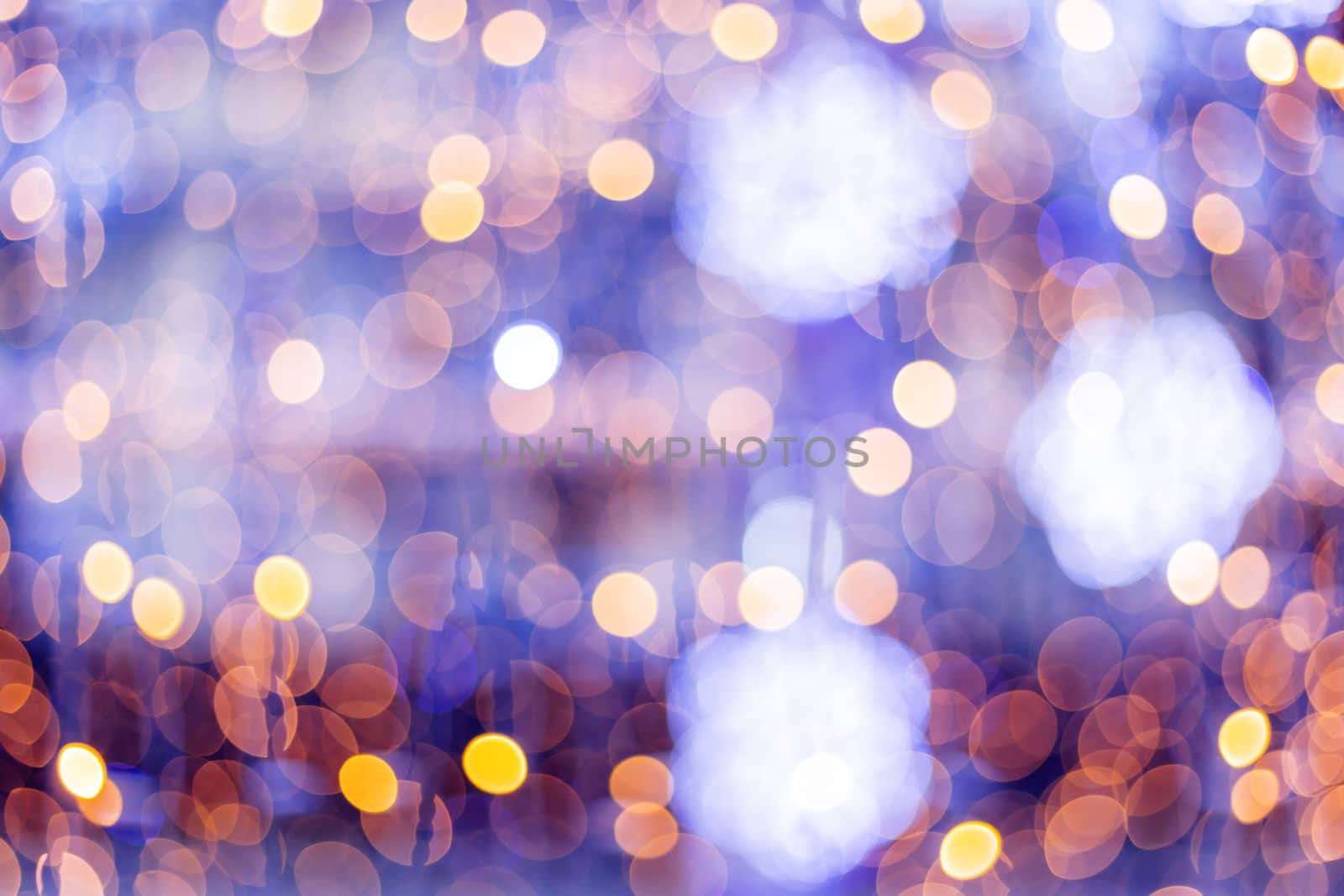 Defocused night street lights, blurred colorful bokeh background. Holiday colorful lanterns and light bulbs garlands.