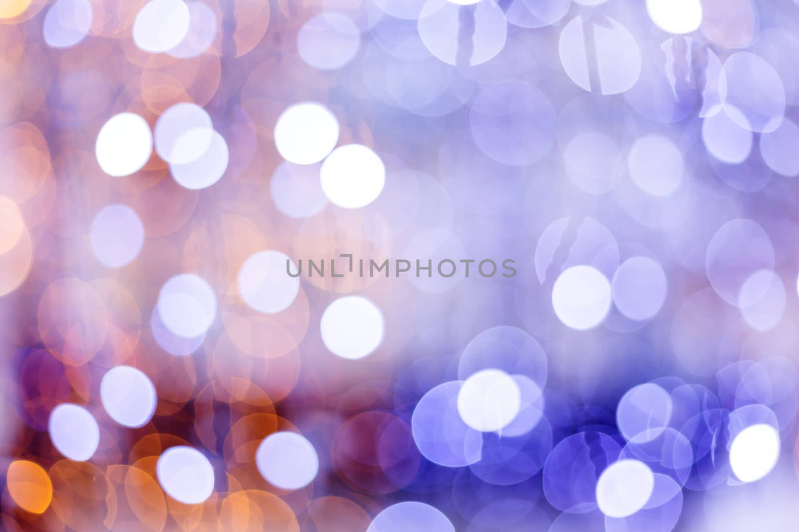 Defocused night street lights, blurred colorful bokeh background. Holiday colorful lanterns and light bulbs garlands.