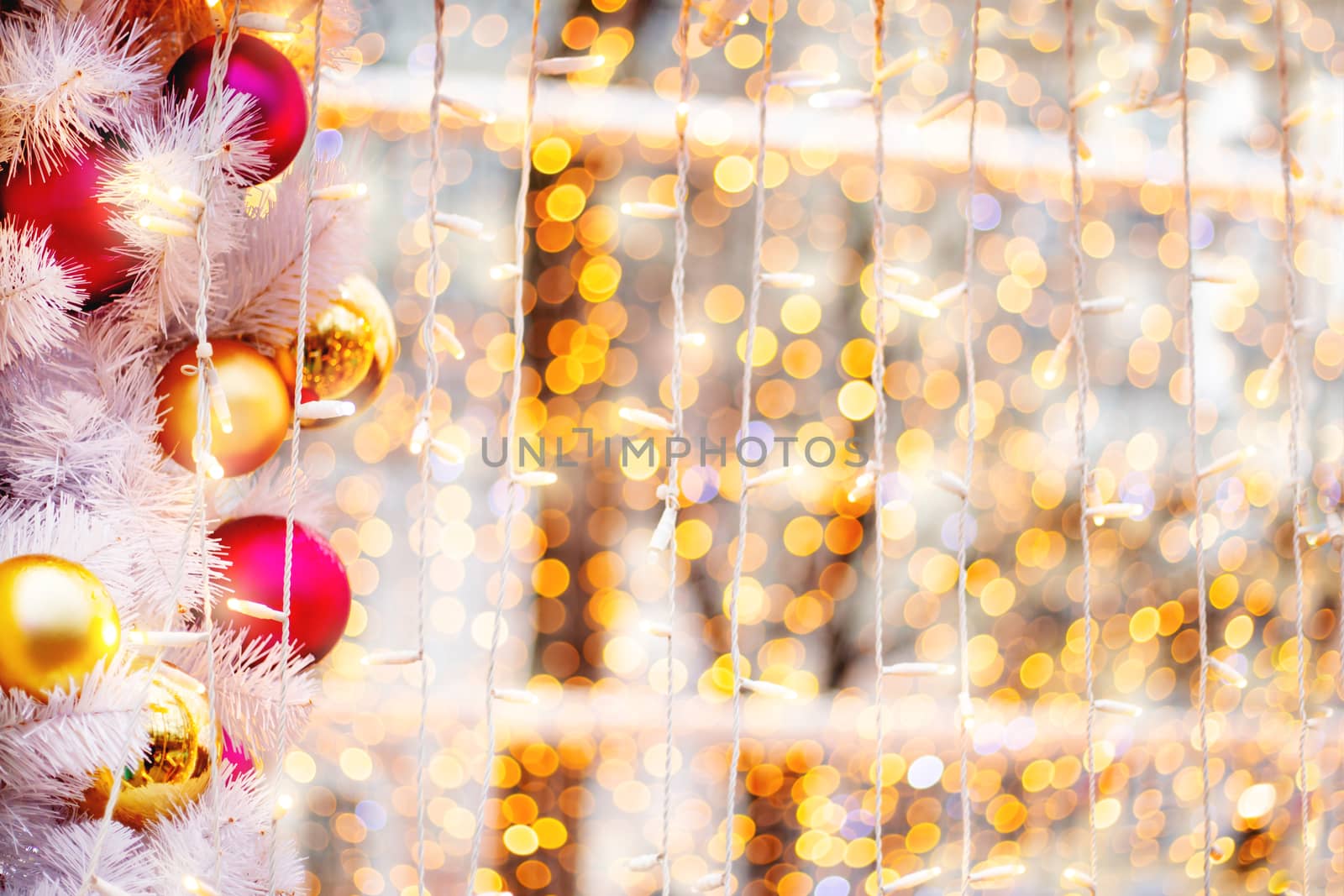 Christmas and New Year outdoors decorations - light bulbs and balls. Festive background.
