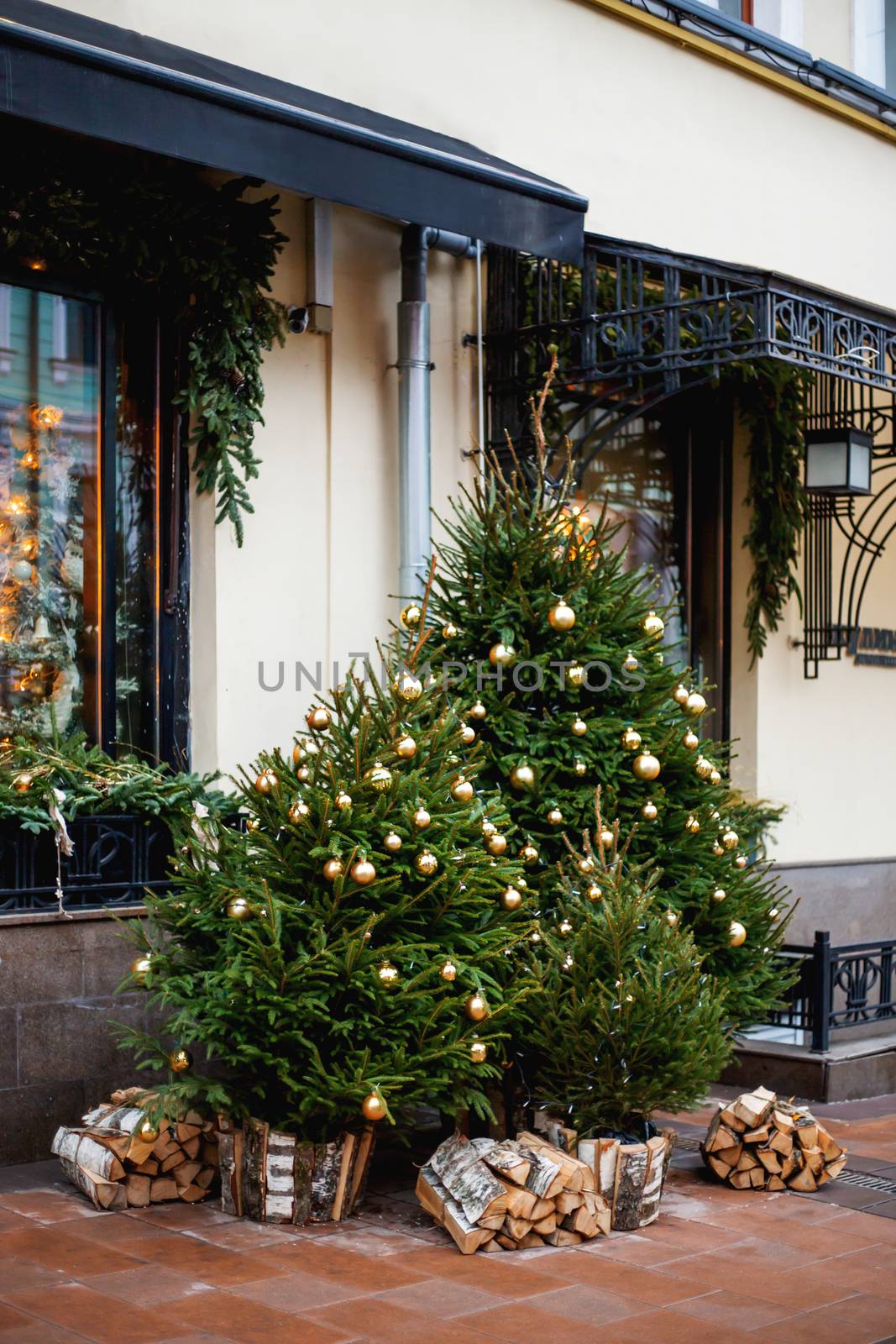 Streets of Moscow decorated for New Year and Christmas celebration. Fir trees with golden balls and light bulbs. Russia. by aksenovko