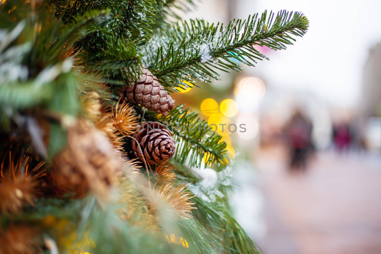 Christmas and New Year outdoor decorations - traditional fir tree wreaths with light bulbs, pine cones and balls.