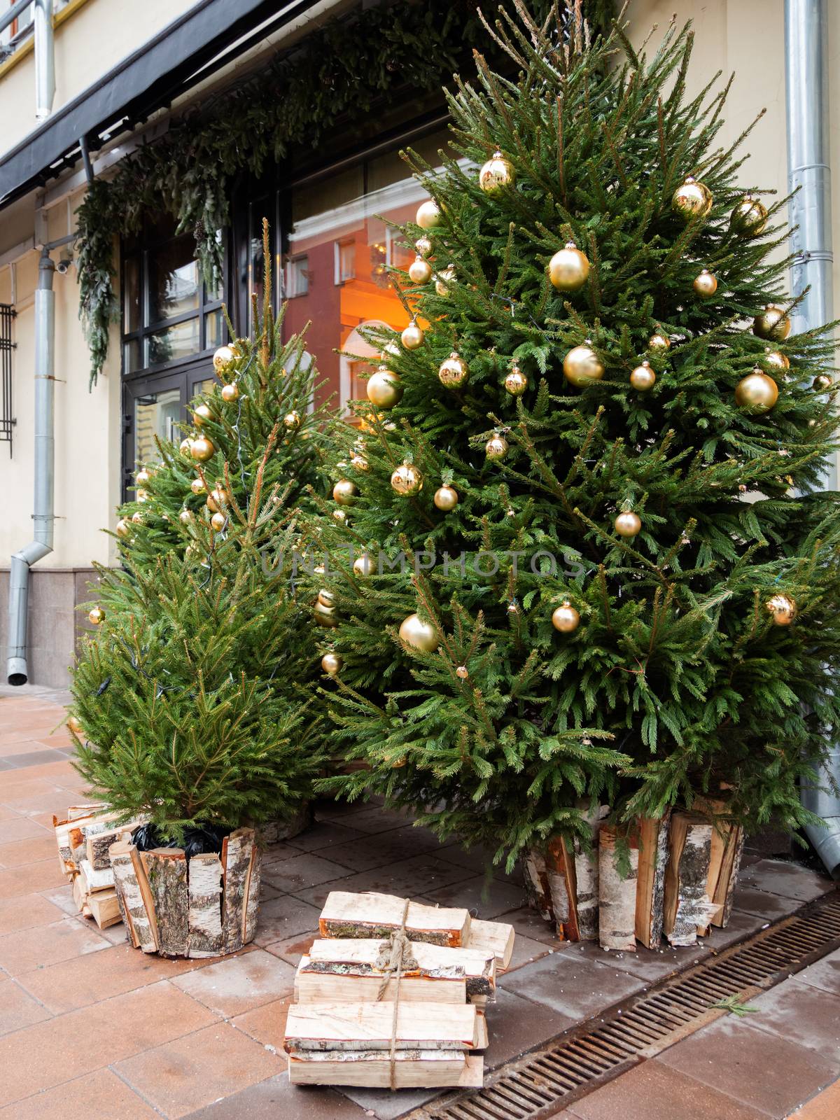 Streets of Moscow decorated for New Year and Christmas celebration. Fir trees with golden balls and light bulbs. Russia. by aksenovko