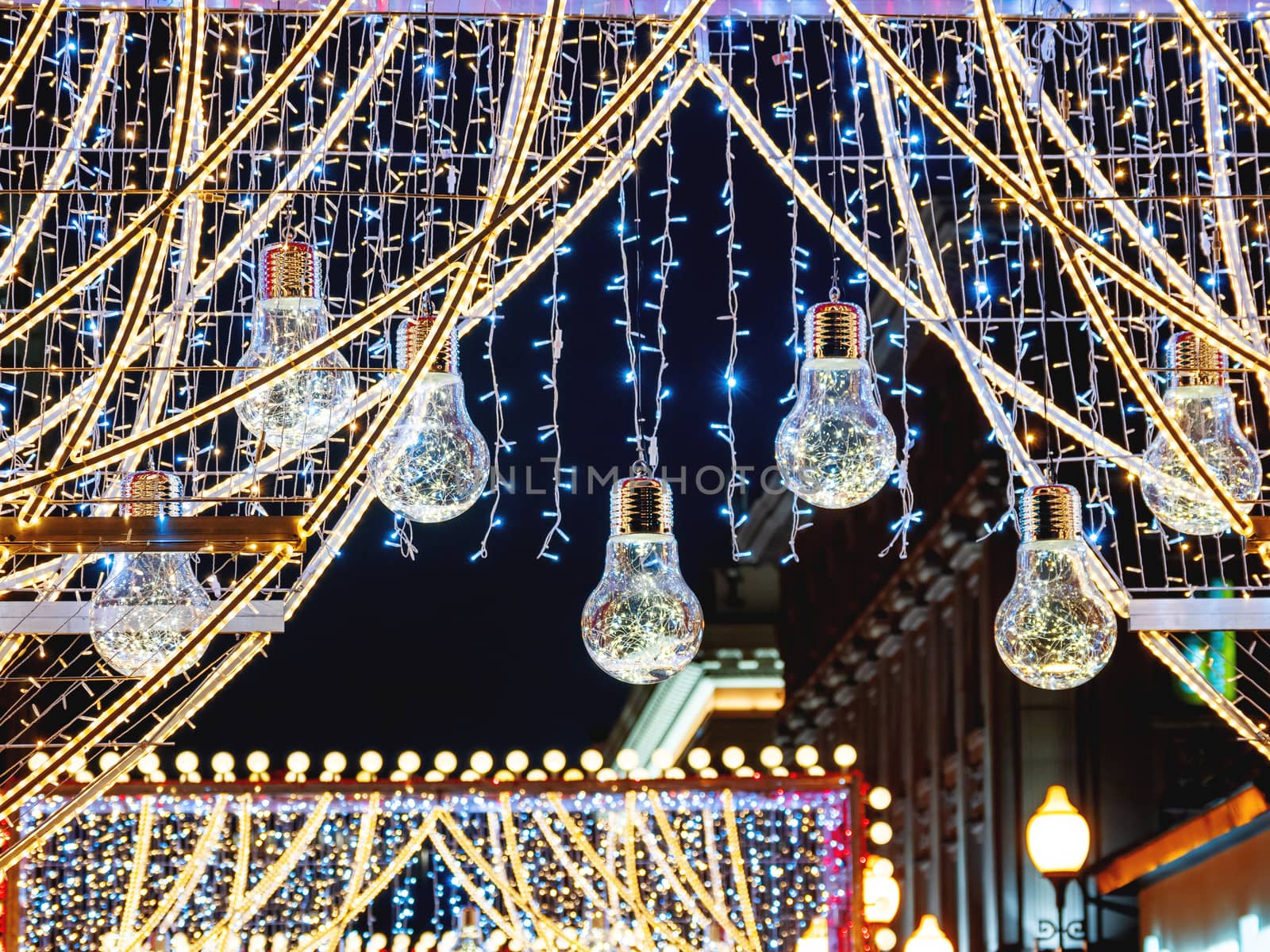 Streets of Moscow decorated for New Year and Christmas celebration. Arch with decorative transparent light bulbs. Russia.