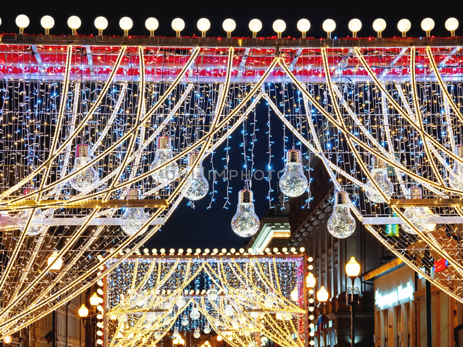 Streets of Moscow decorated for New Year and Christmas celebration. Arch with decorative transparent light bulbs. Russia.