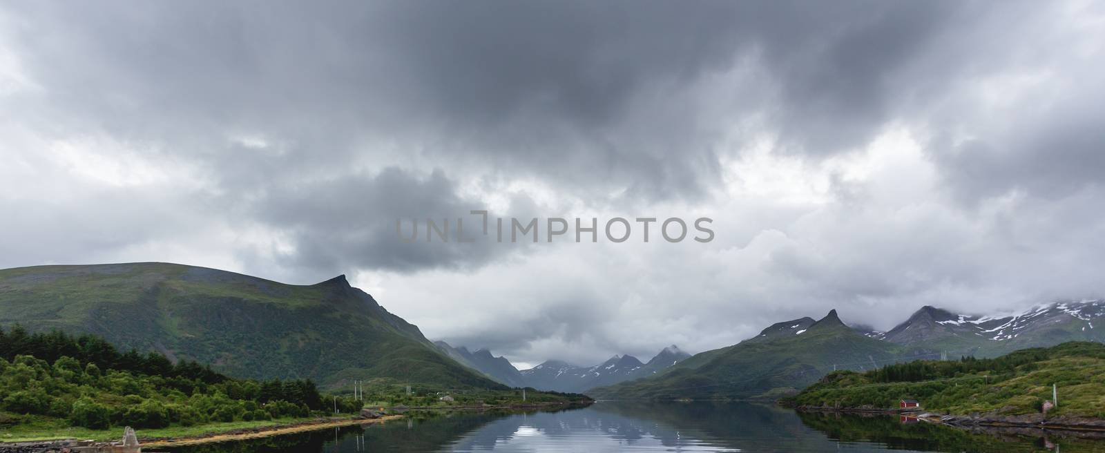 Beautiful scandinavian landscape with fjord, mountains and stormy sky. Lofoten islands, Norway.