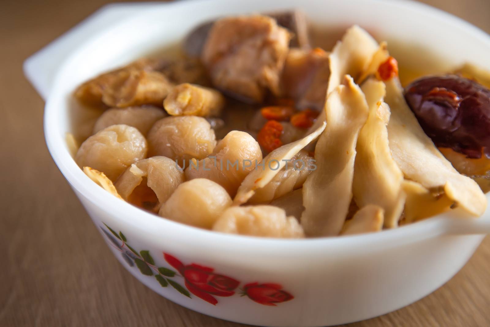 chinese herbal soup on wooden bachground