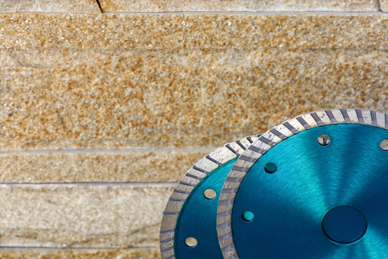 Aquamarine green diamond circles for brick and stone, against the orange-golden sandstone wall.