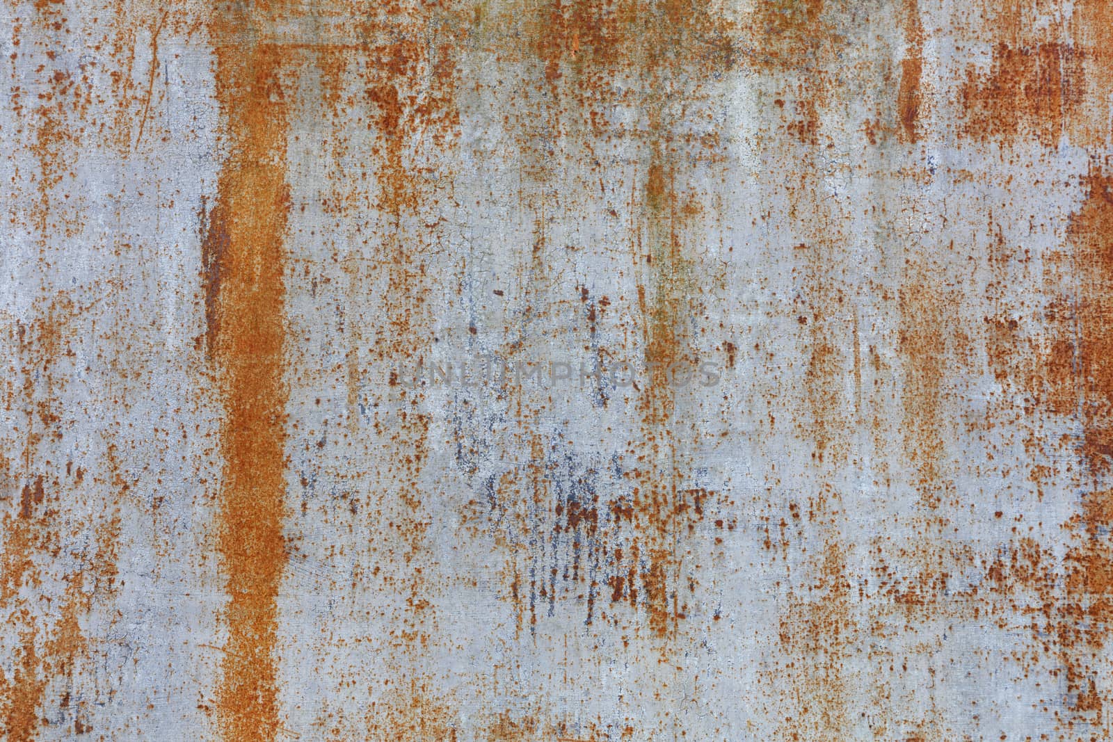 Old metal sheet with rust texture and gray weathered cracked paint.