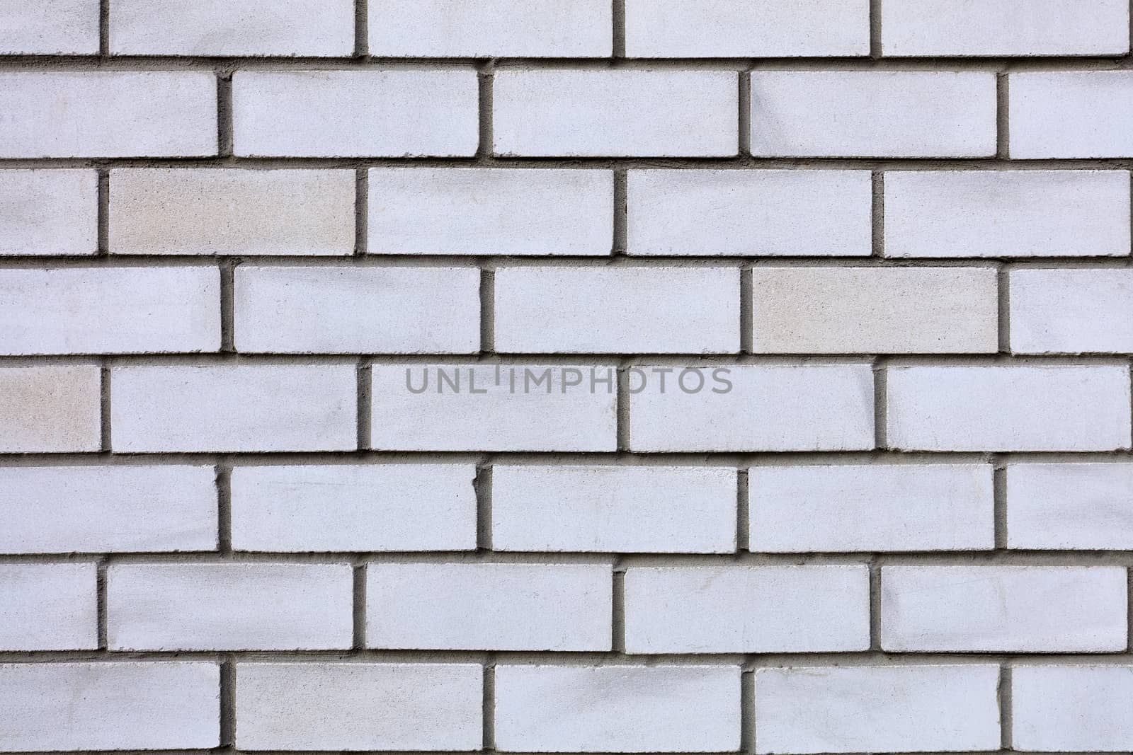 The texture of the wall is made of gray and white bricks laid horizontally.