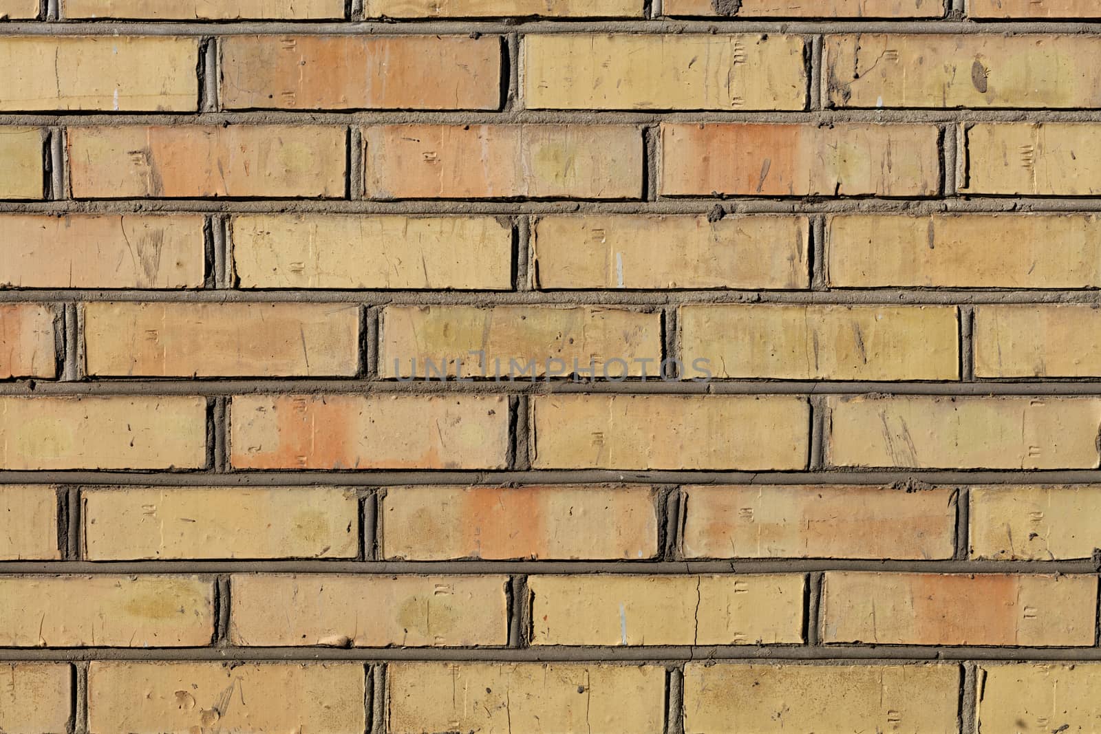 The pronounced texture of the old brick on the wall with cement jointing. by Sergii