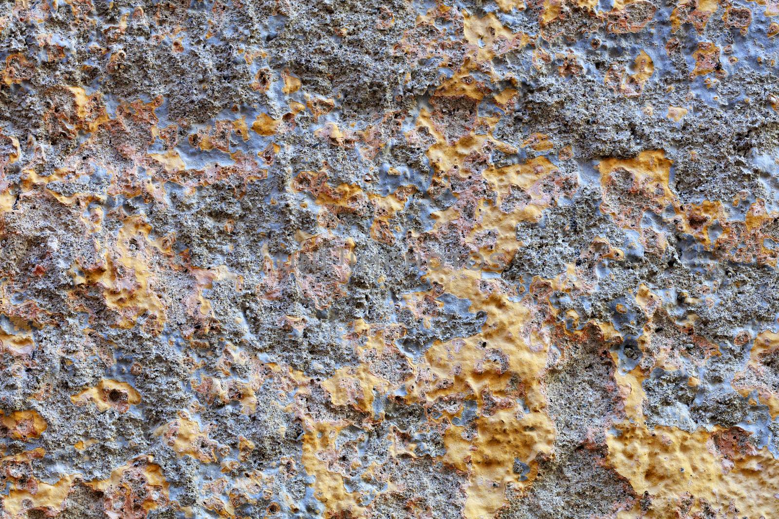 Gold fragments appear on the gray-blue plaster of the old wall.
