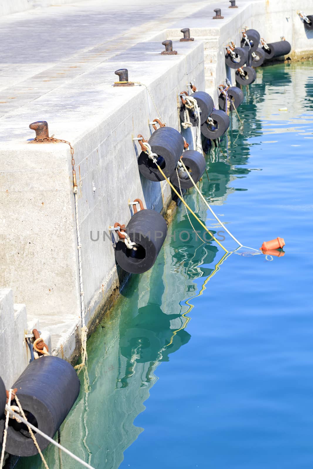 Bollards and mooring wing on a sea pier. by Sergii