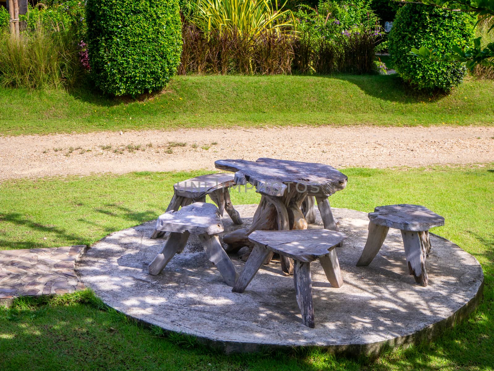 Old wooden table set  in the green garden.