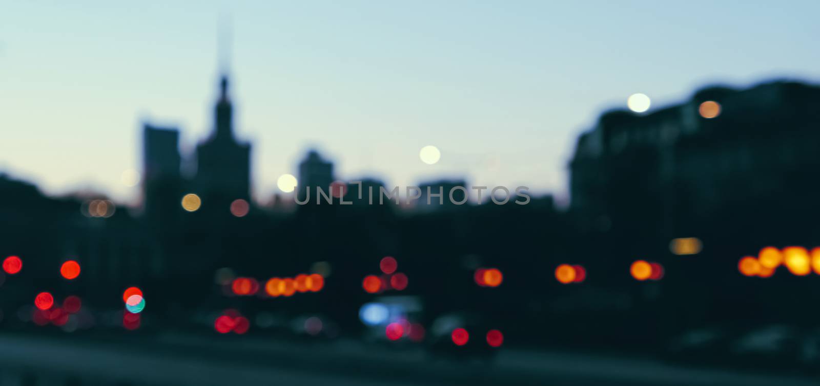 Blurry cityscape silhouette of a European city as background, evening view by Anneleven