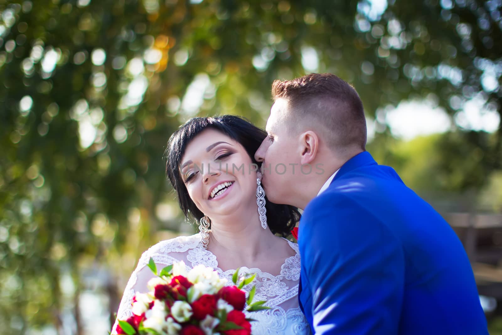 Bride and groom. Happy bride and kissing groom