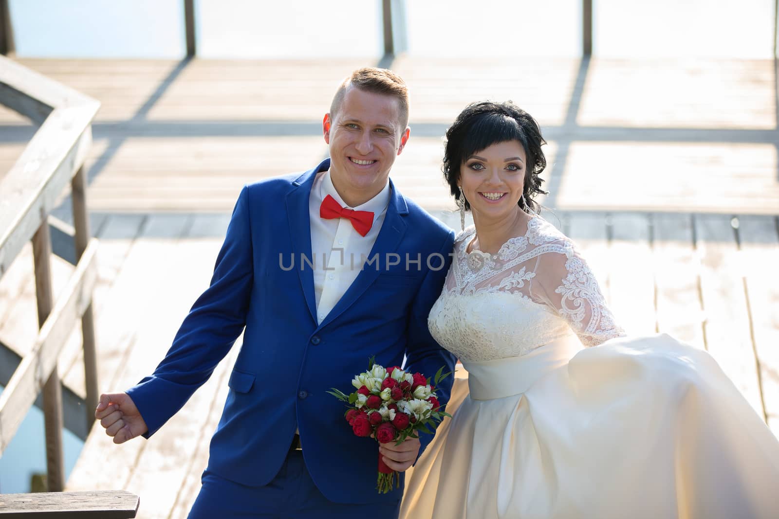 The bride and groom are happy at the wedding walk. Portrait of the bride and groom