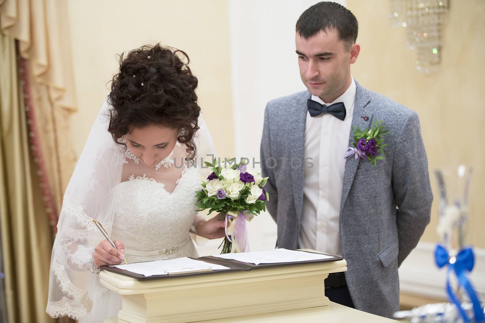 The bride and groom register in the registry office