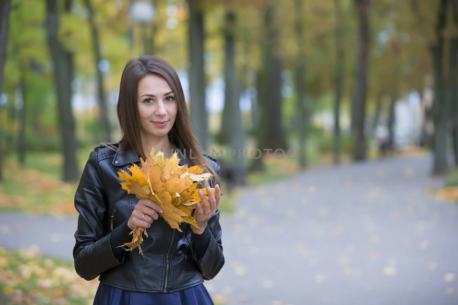 Woman with autumn leaves