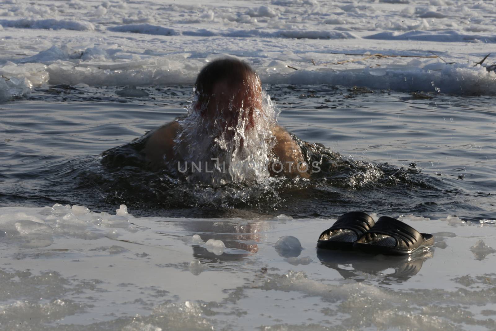 Belarus, Gomel, January 19, 2017, the celebration of the baptism of Jesus Christ.A man is plunged into an ice-hole.Bathing in ice water. The Baptism of Jesus. Religious holiday