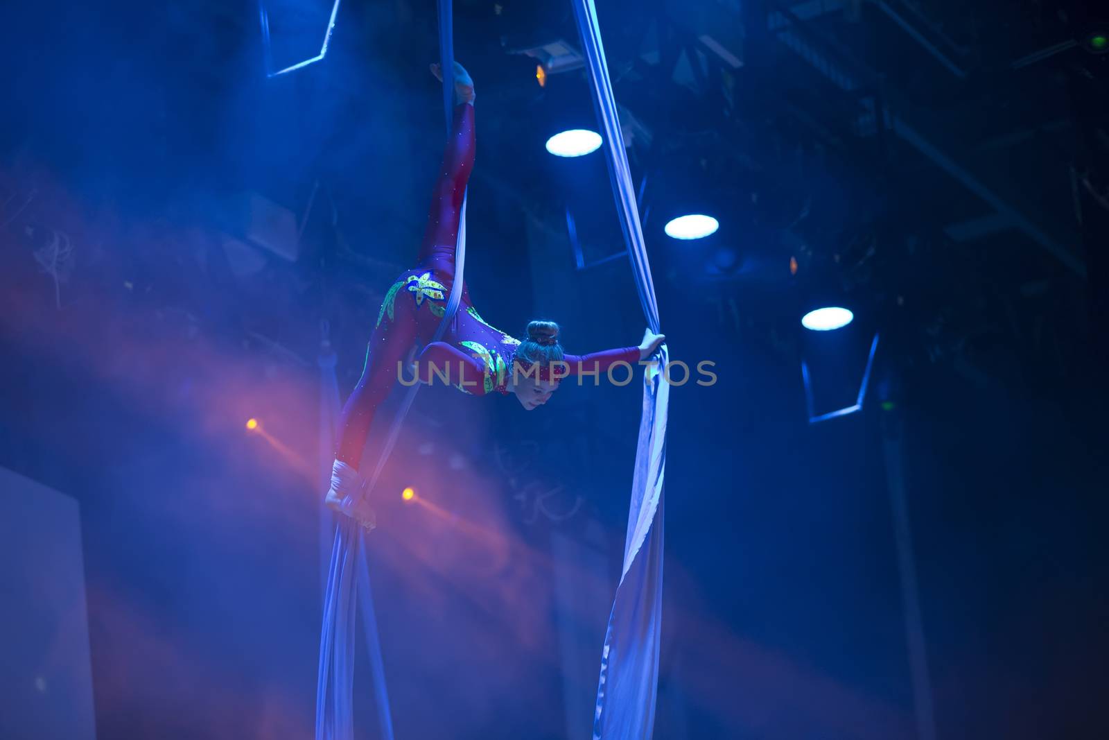 A girl dancing a dance on canvases.Children's sports. Girl gymnast. Straight tricks