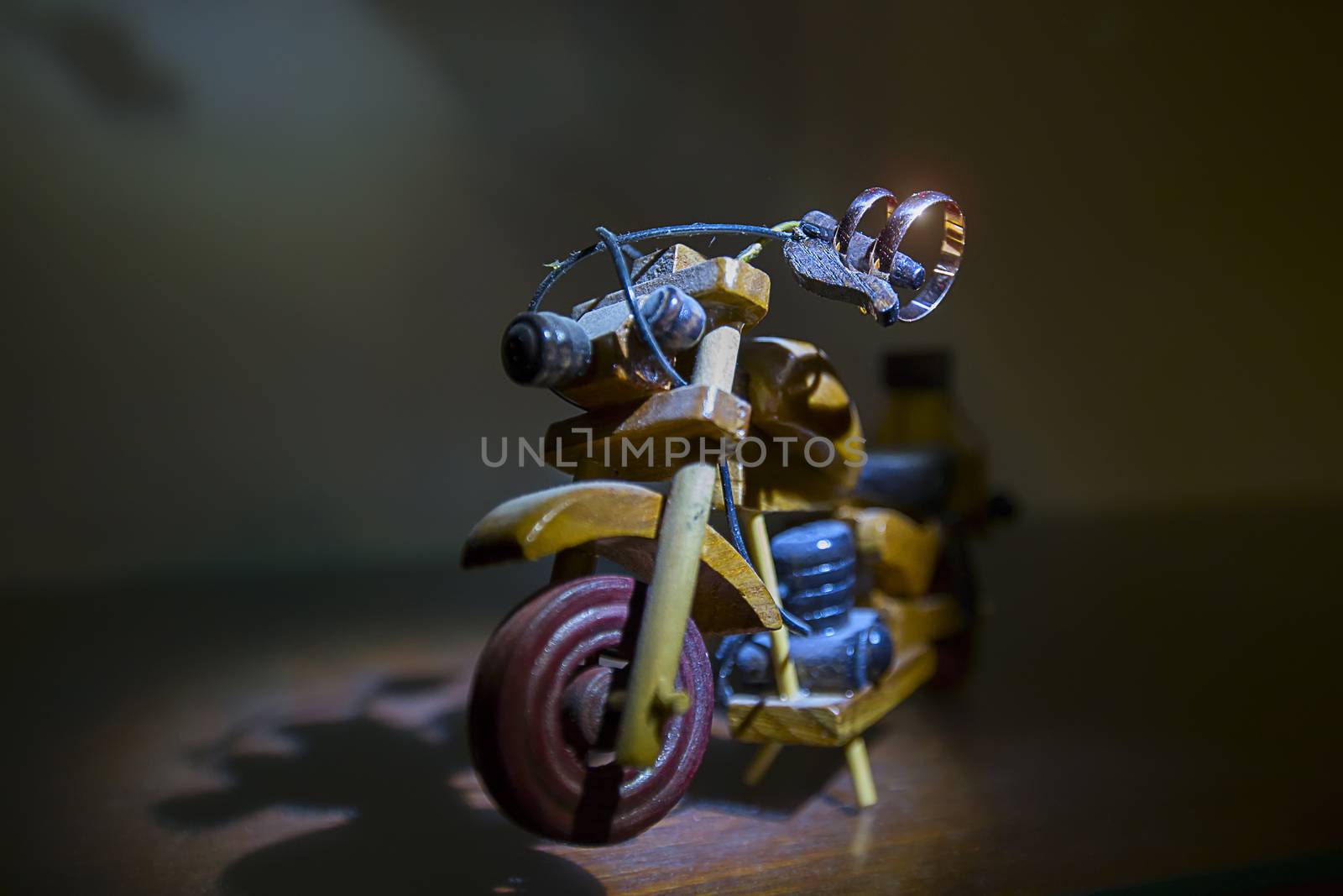 Wedding rings on a toy wooden motorcycle.Wedding biker. Wedding rings. Wedding day.