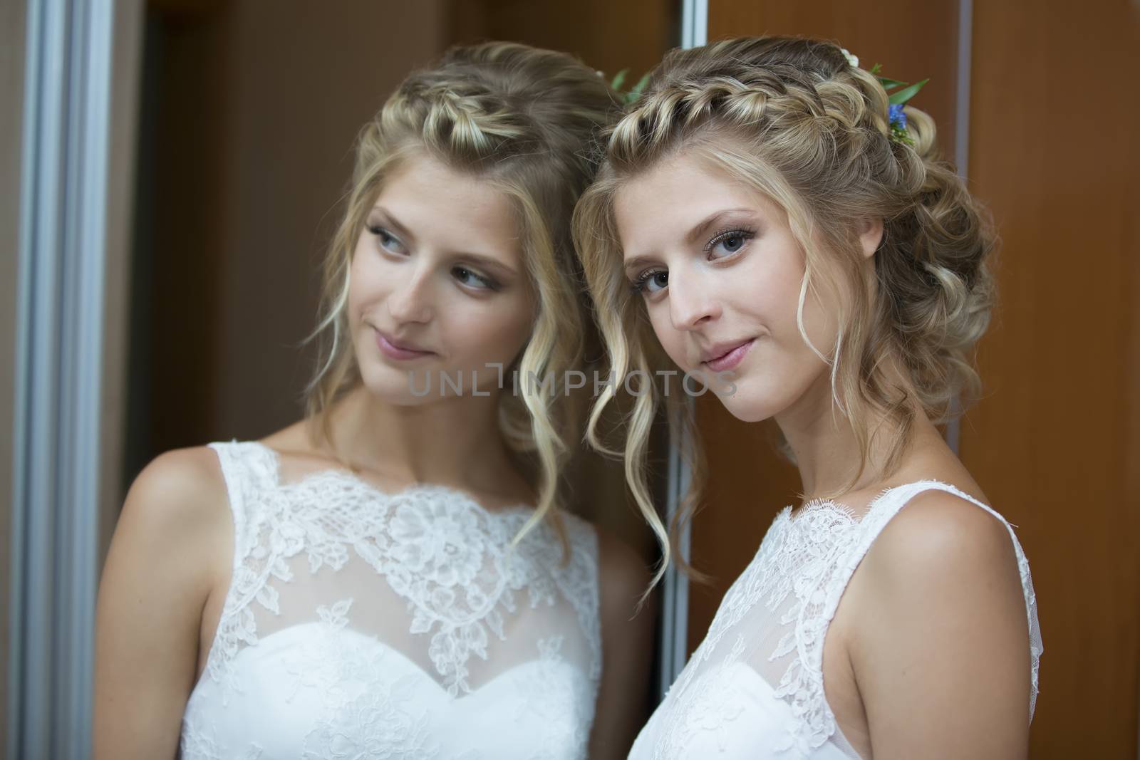 Portrait of the bride near the mirror.Wedding day. The bride before the wedding. Beautiful bride. by Sviatlana