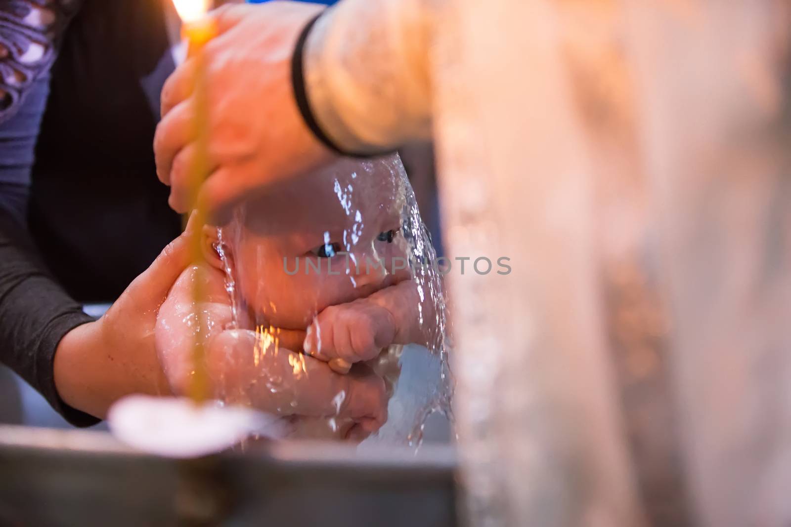 Baptism of the Child.The infant is washed on the rite of baptism.Baptism of the baby. Accept the faith. Newborn in the church.