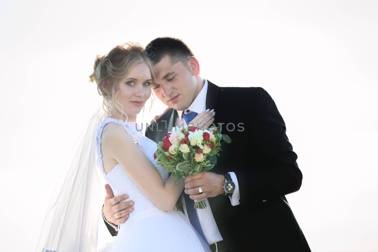 Bride and groom on wedding day with bouquet