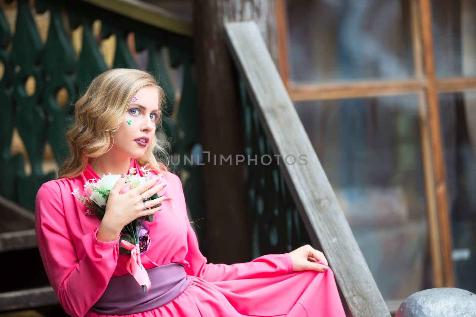 love girl in a pink dress with a bouquet