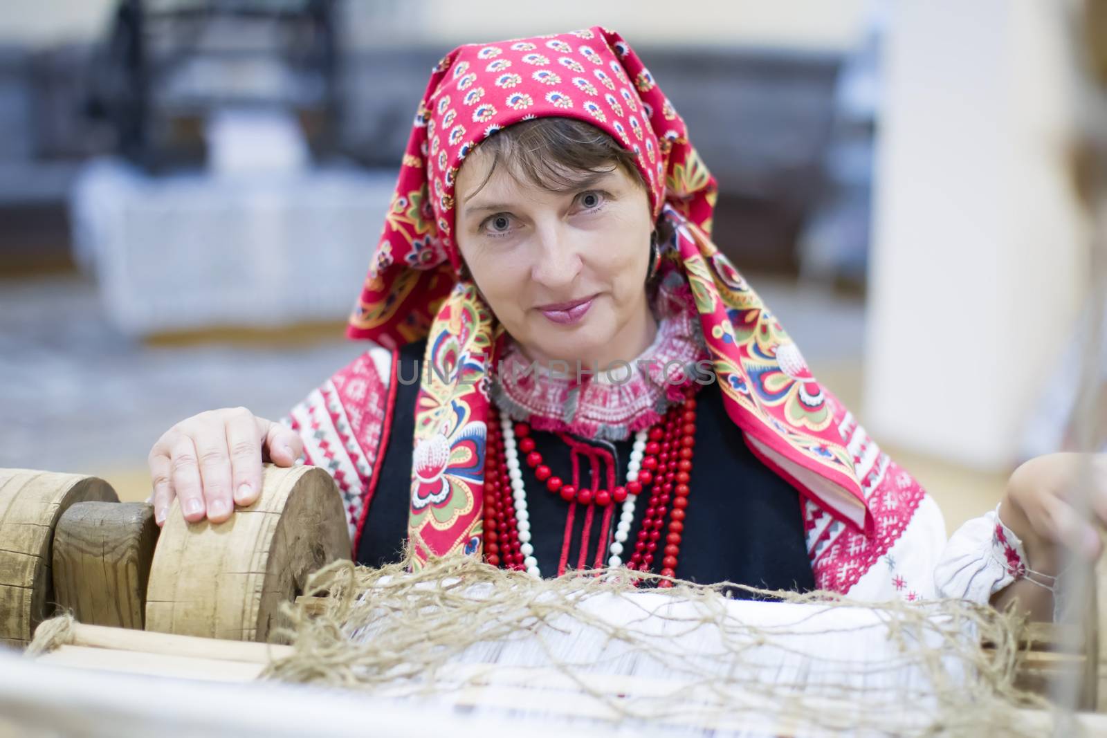 Belarus, Gomel, September 15, 2017. The city's birthday. A Belarusian woman is weaving a towel. Take up weaving. Spin the towel.