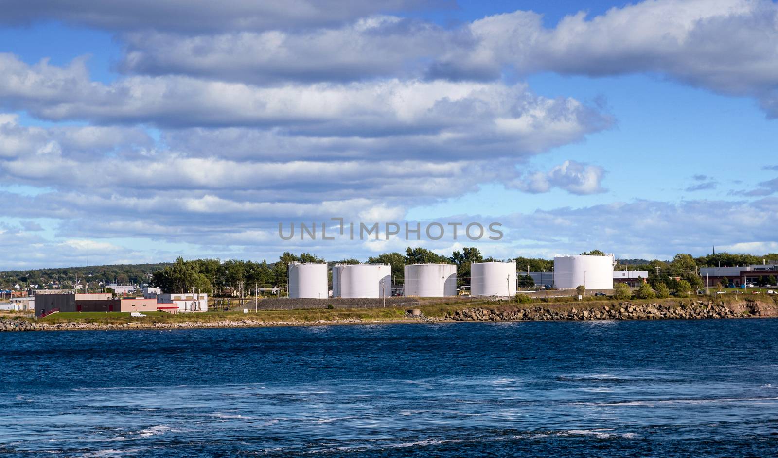 White petroleum tanks on the coast of the Canadian wilderness