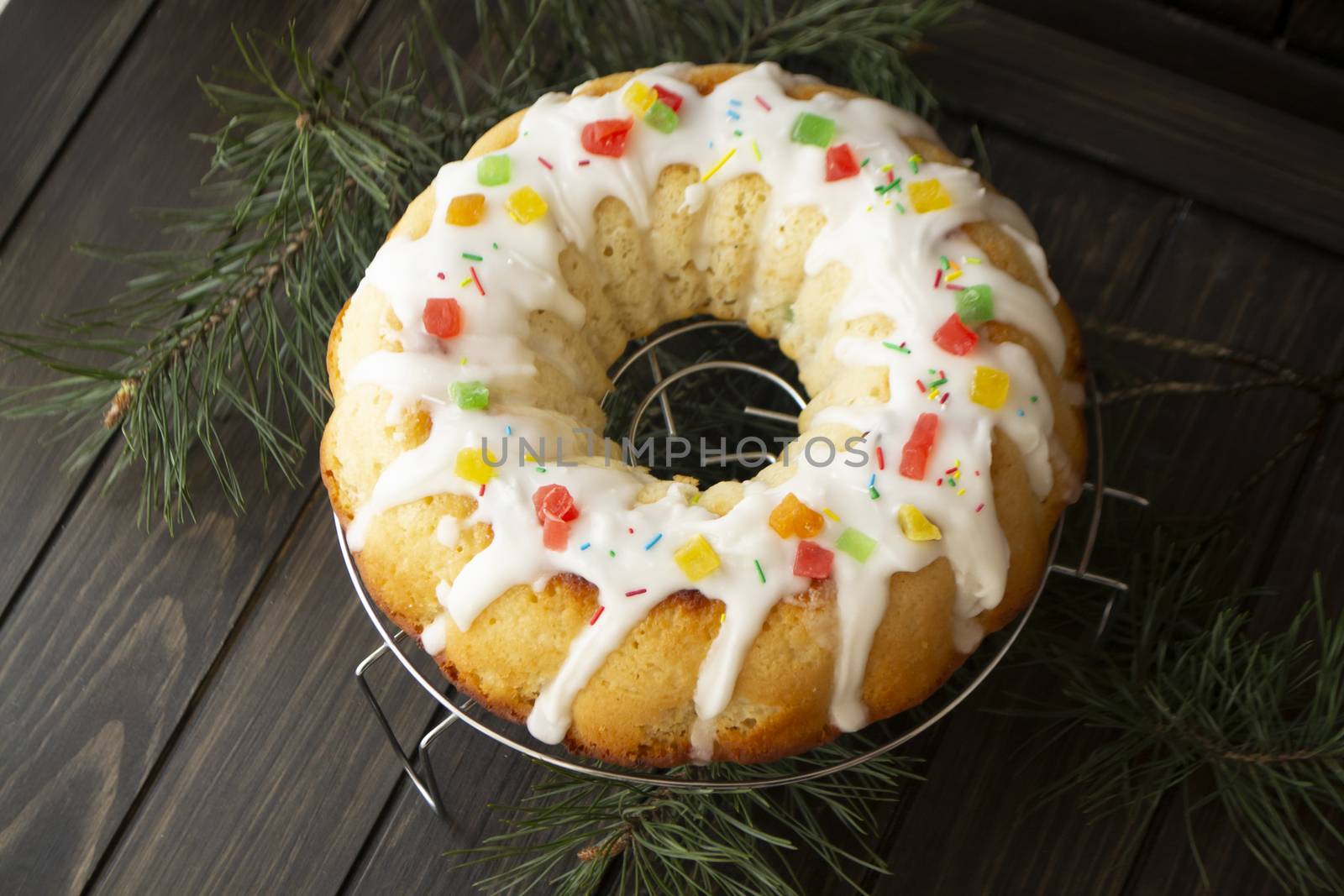 Traditional yeast cake covered with white icing and raisins Spongy yeast cake that is traditionally baked for Easter. Flat lay