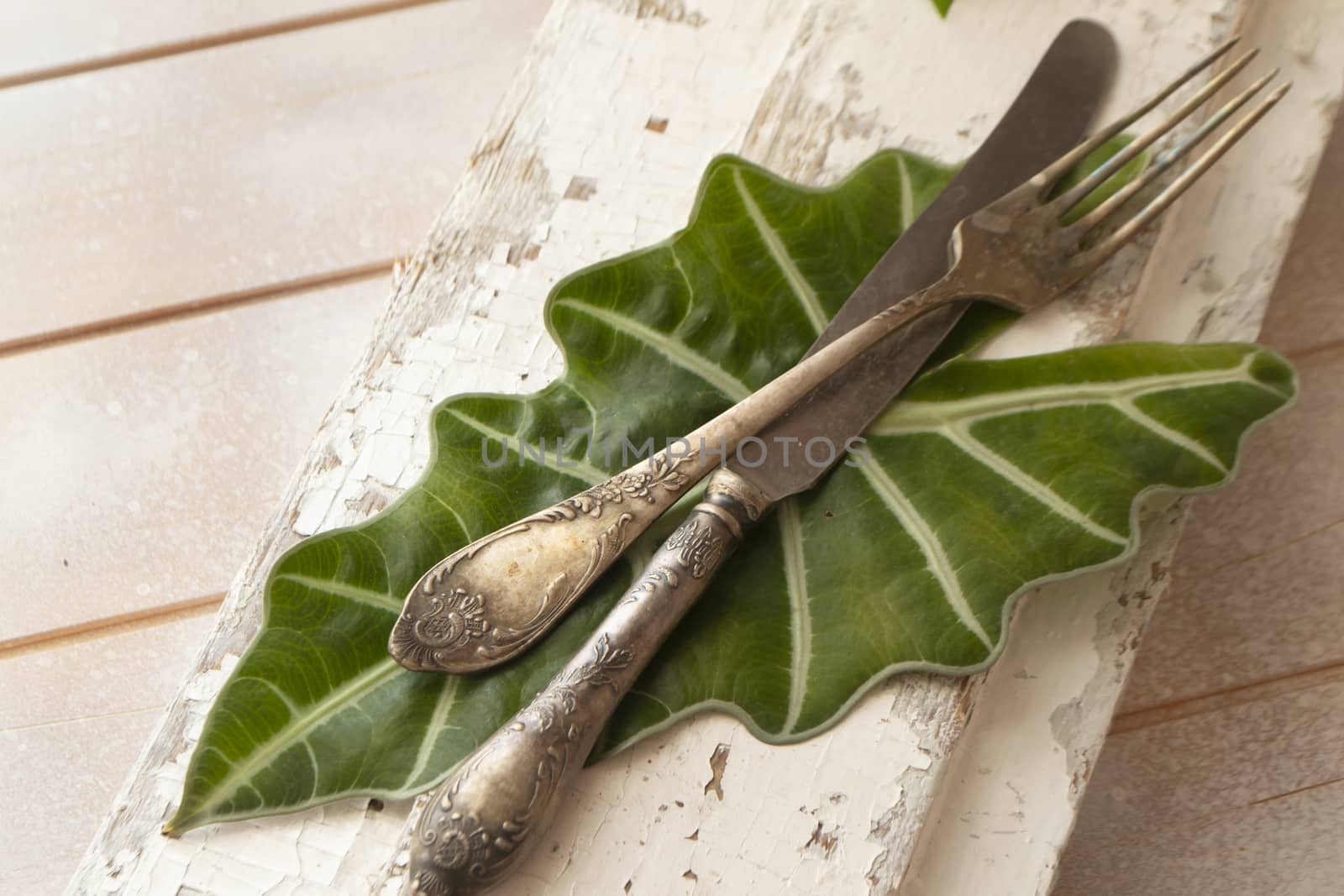old fork with knife over the white shabby table