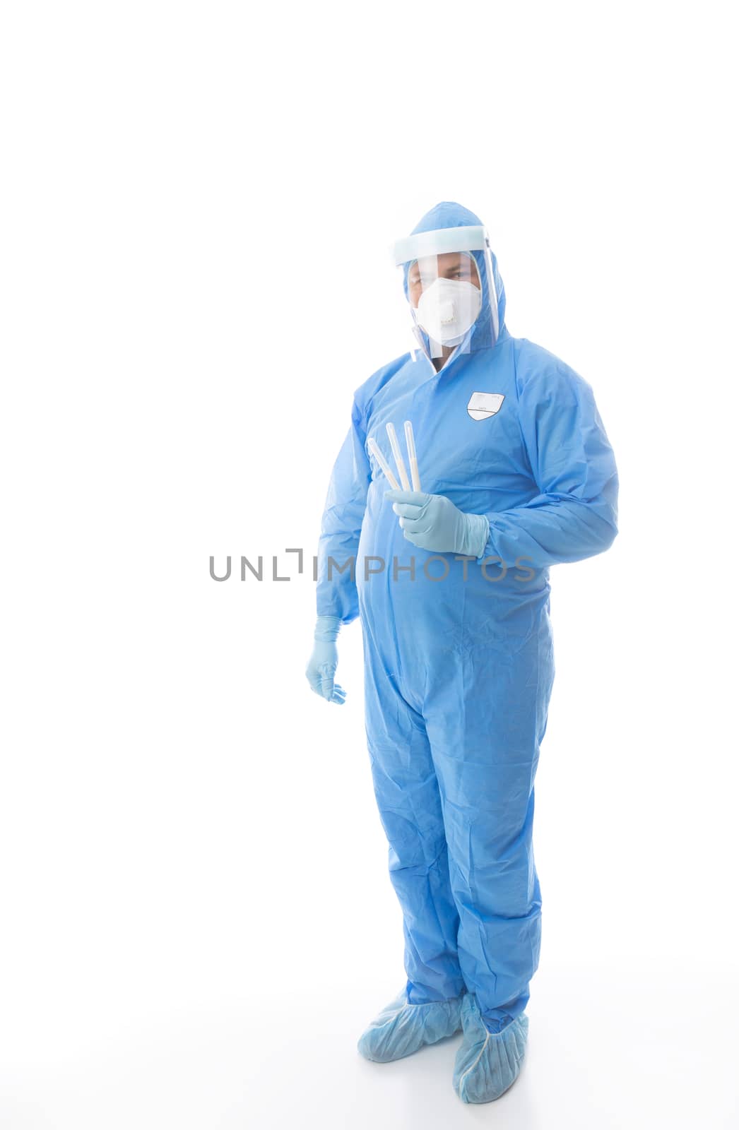 Healthcare worker in full PPE holding swabs for coronavirus pandemic by lovleah