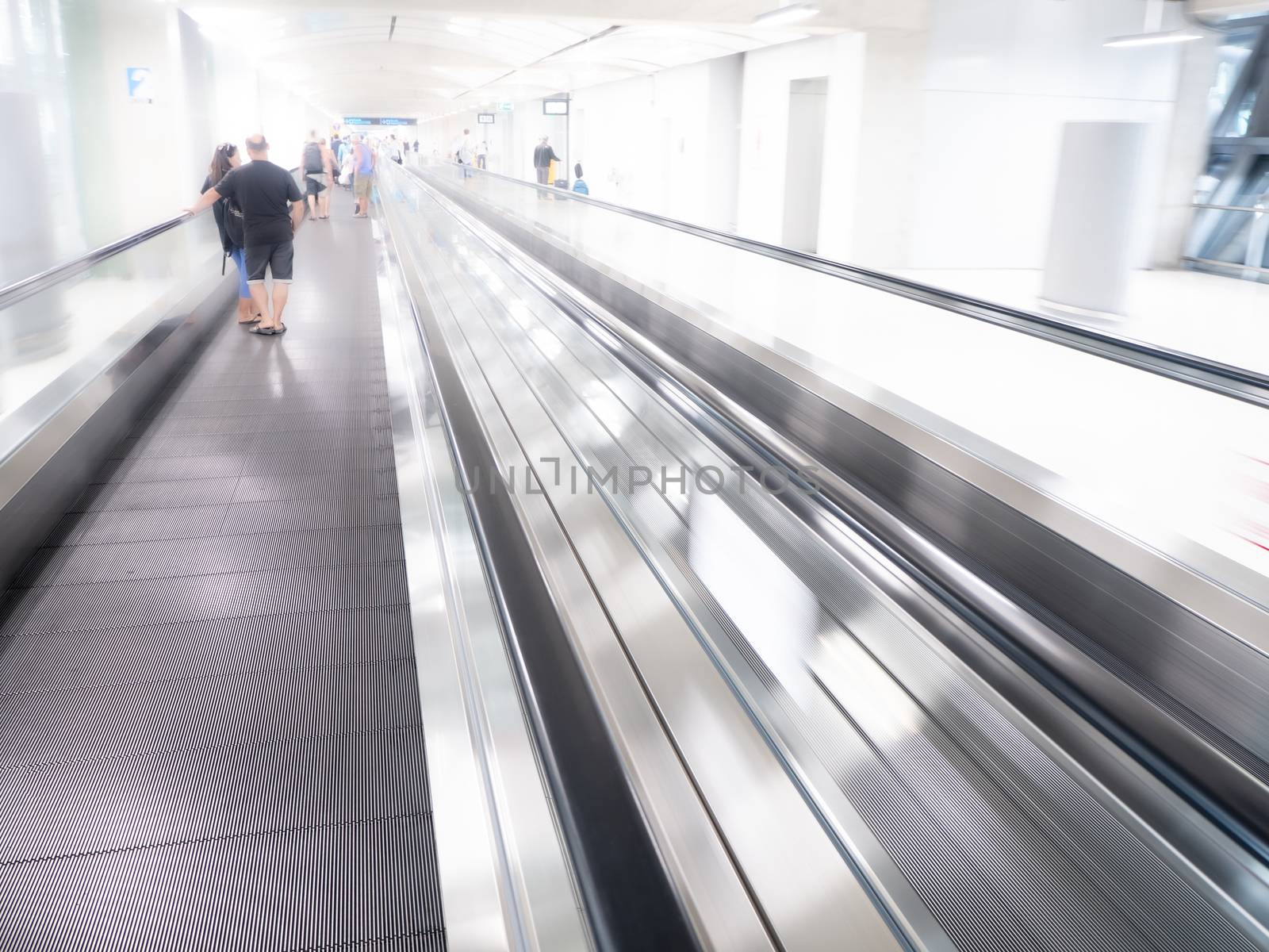 The skywalk with blurred business people in airport