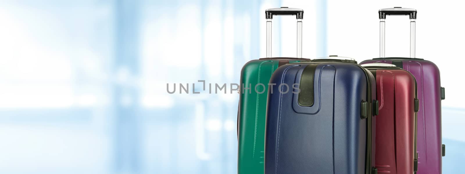 Travel concep banner - group of various travel suitcases on a blurred background of the airport (copy space)