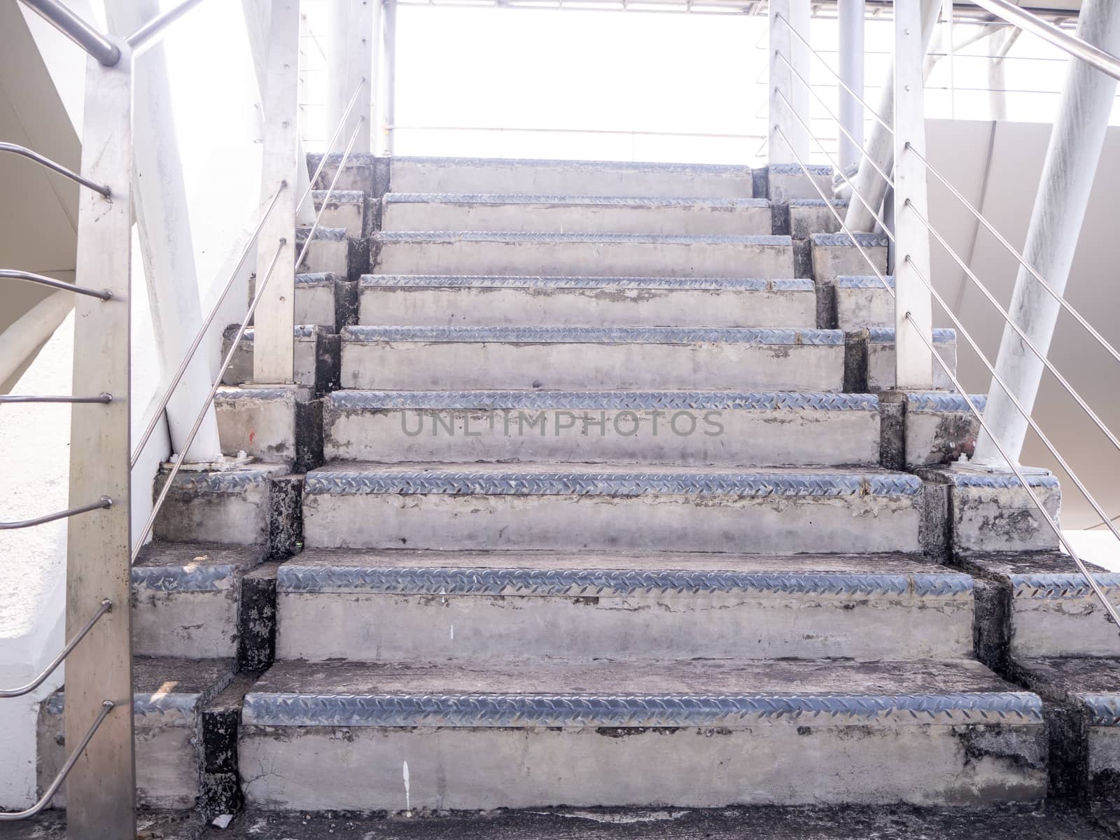 staircase for descending from footbridge. The concrete overpass for crossing the road.
