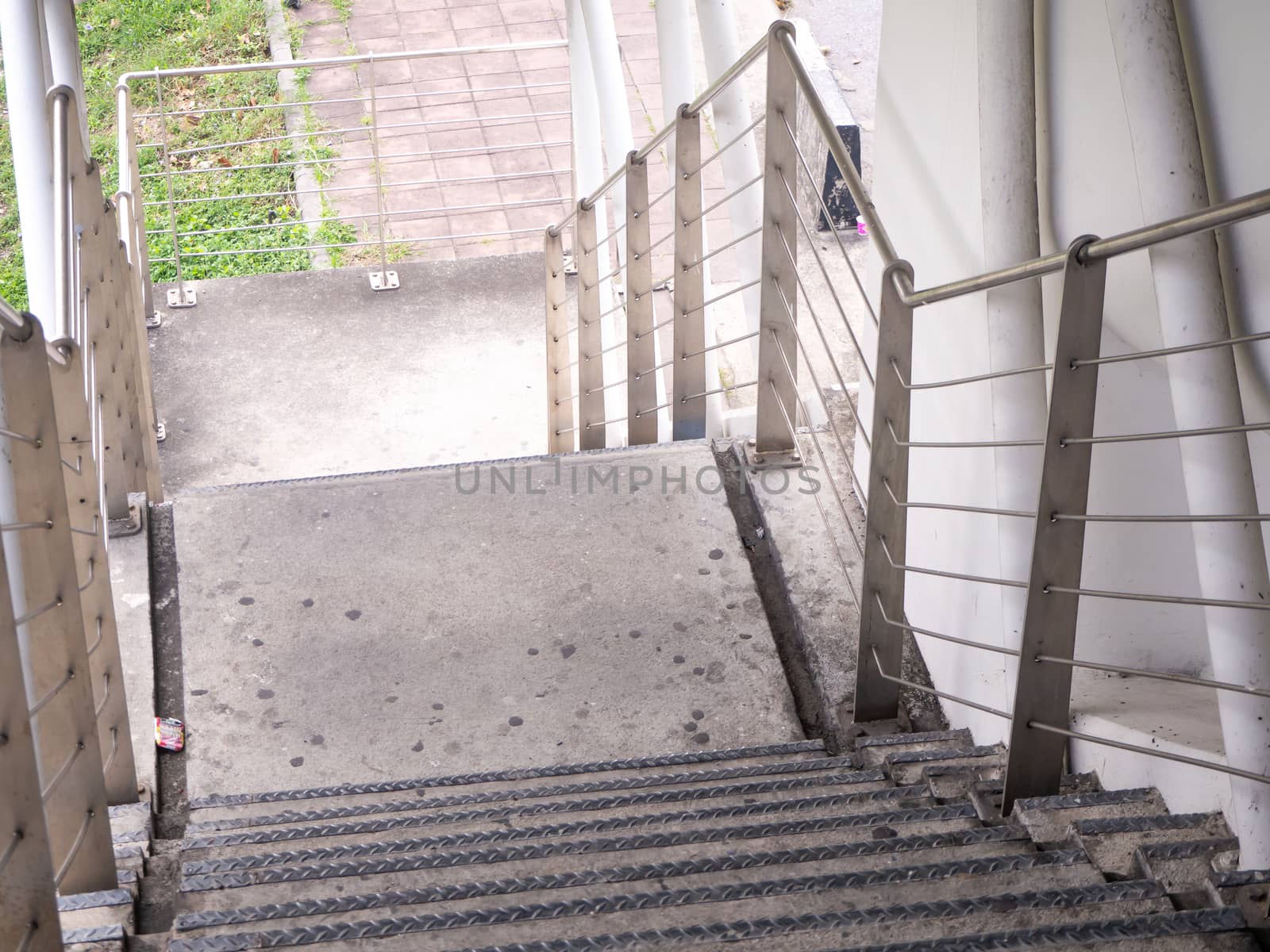 staircase for descending from footbridge. The concrete overpass for crossing the road.